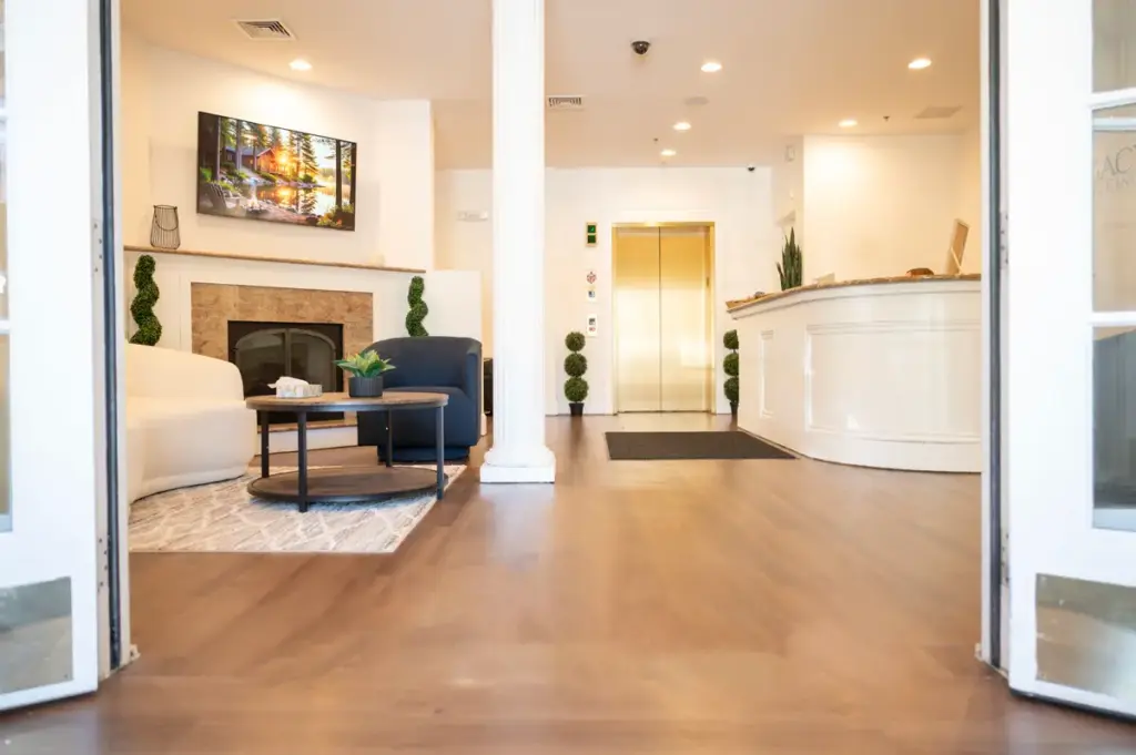 Reception area at Shore Point Recovery Center with front desk, elevator, and welcoming lounge seating