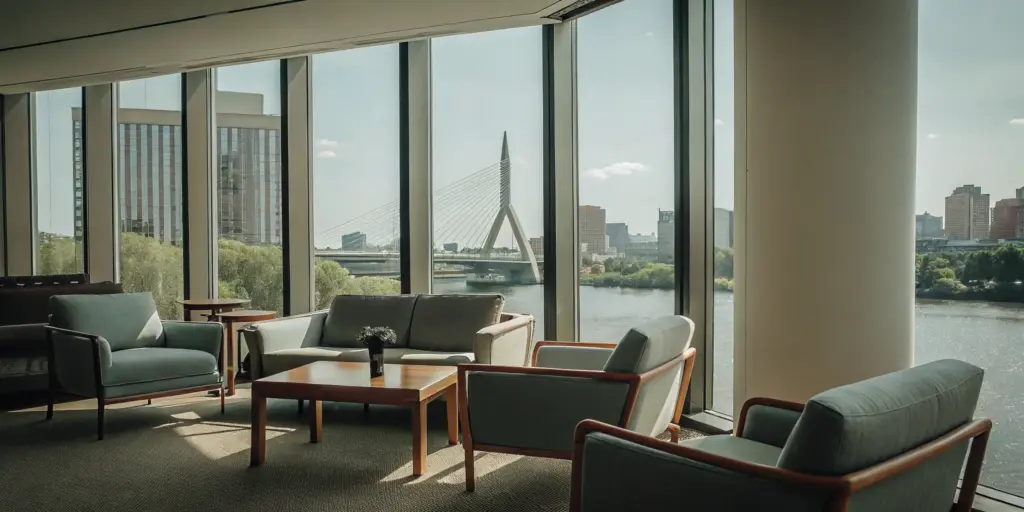 Modern lounge in a Boston drug rehab center with serene city and river views.