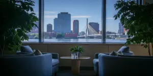 Serene lounge in a Boston rehab center overlooking the city skyline.