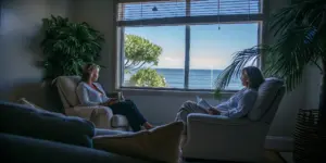 Private therapy room with comfortable seating and natural coastal light at a luxury treatment center